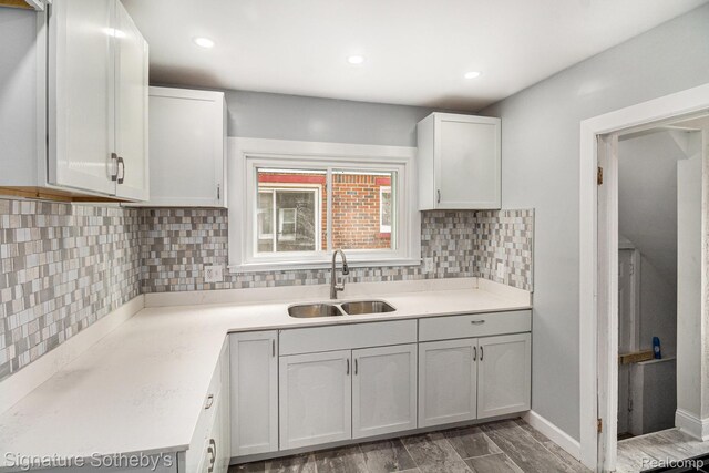 16762 Woodingham Dr, Detroit, MI 48221 - kitchen featuring a sink, tasteful backsplash, light countertops, white cabinets, and recessed lighting