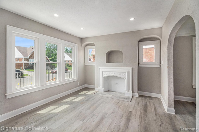16762 Woodingham Dr, Detroit, MI 48221 - unfurnished living room featuring wood finished floors, healthy amount of natural light, baseboards, and recessed lighting