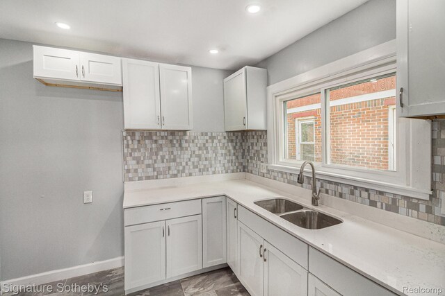 16762 Woodingham Dr, Detroit, MI 48221 - kitchen with a sink, decorative backsplash, light countertops, baseboards, and recessed lighting