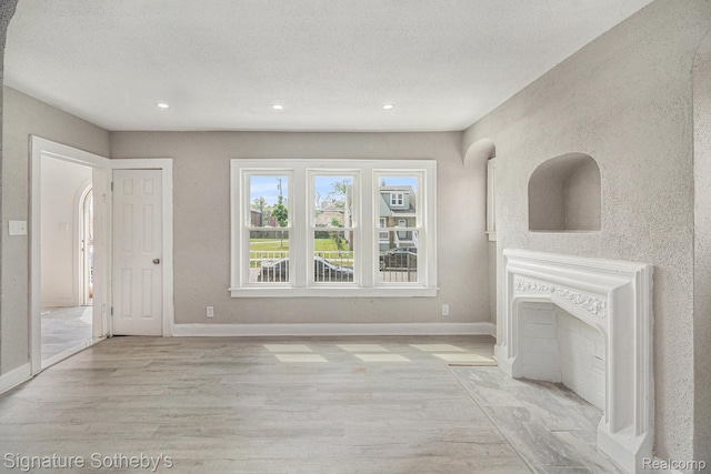16762 Woodingham Dr, Detroit, MI 48221 - unfurnished living room featuring wood finished floors, baseboards, recessed lighting, and a textured ceiling
