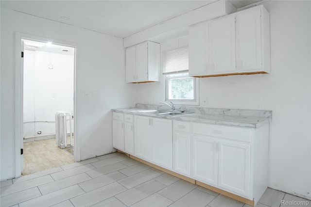 16131 Lenore, Detroit, MI 48219 - kitchen featuring radiator, light countertops, and white cabinets