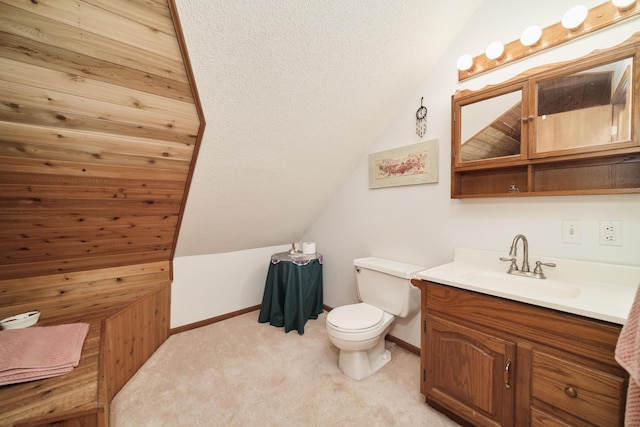 6387 N Larson Rd, Fountain, MI 49410 - bathroom with toilet, vaulted ceiling, vanity, and baseboards