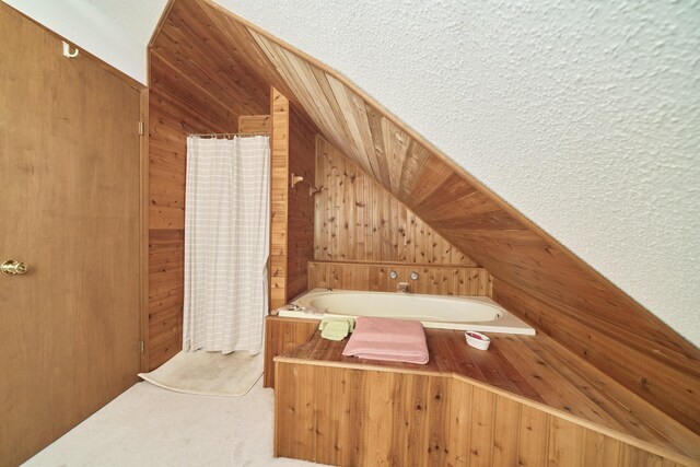 6387 N Larson Rd, Fountain, MI 49410 - bathroom featuring wood walls, a bath, and vaulted ceiling