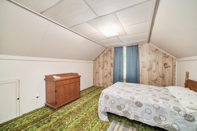 6387 N Larson Rd, Fountain, MI 49410 - carpeted bedroom featuring wood walls and lofted ceiling