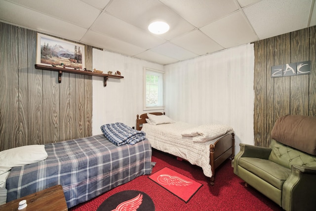 6387 N Larson Rd, Fountain, MI 49410 - bedroom with a drop ceiling, wood walls, and carpet floors