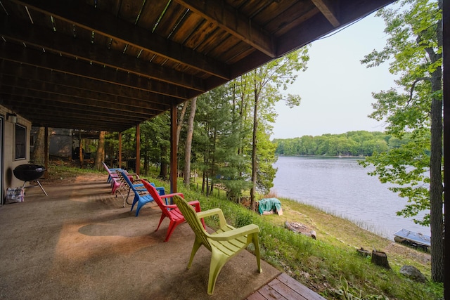 6387 N Larson Rd, Fountain, MI 49410 - view of patio featuring a water view, a grill, and a forest view