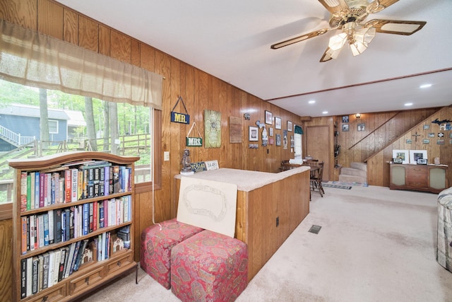 6387 N Larson Rd, Fountain, MI 49410 - living area featuring wood walls, carpet flooring, plenty of natural light, stairway, and a ceiling fan
