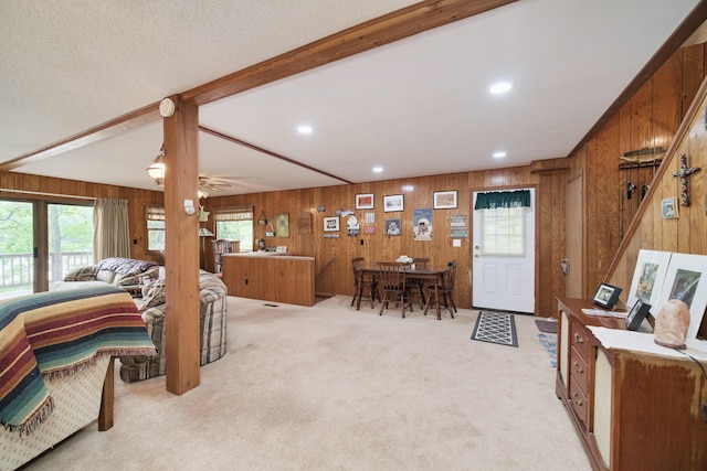 6387 N Larson Rd, Fountain, MI 49410 - living area with wood walls, healthy amount of natural light, light carpet, beam ceiling, and recessed lighting