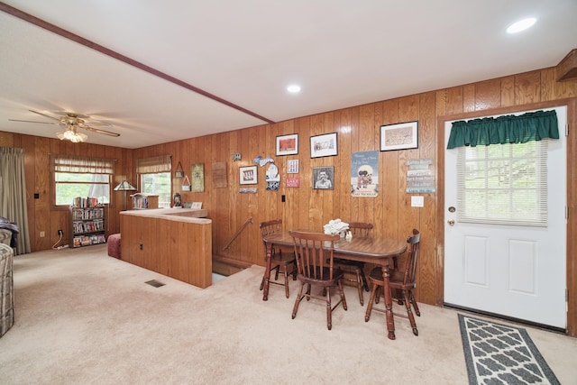 6387 N Larson Rd, Fountain, MI 49410 - dining room featuring light carpet, ceiling fan, wooden walls, and recessed lighting