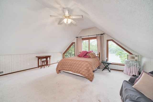 6387 N Larson Rd, Fountain, MI 49410 - carpeted bedroom with lofted ceiling, a ceiling fan, wallpapered walls, and a textured ceiling
