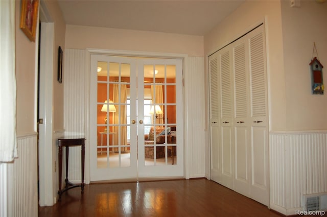 6560 Perham Dr, West Bloomfield, MI 48322 - unfurnished bedroom with french doors, wood finished floors, a closet, and wainscoting