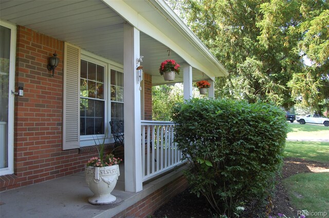 6560 Perham Dr, West Bloomfield, MI 48322 - property entrance featuring a porch and brick siding