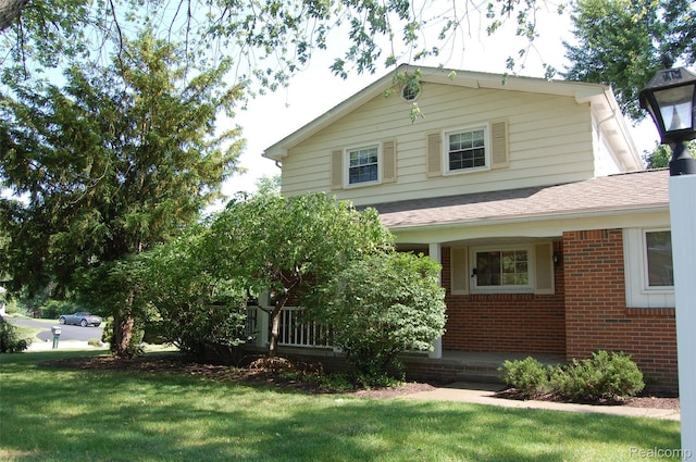 6560 Perham Dr, West Bloomfield, MI 48322 - view of front of home with brick siding, a front yard, and a shingled roof