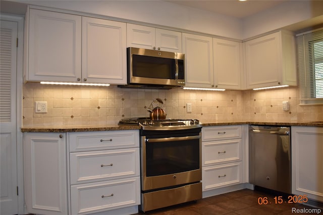 6560 Perham Dr, West Bloomfield, MI 48322 - kitchen with appliances with stainless steel finishes, white cabinets, backsplash, and dark stone counters
