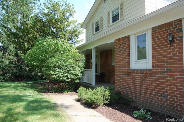 6560 Perham Dr, West Bloomfield, MI 48322 - entrance to property featuring a porch, brick siding, and a lawn