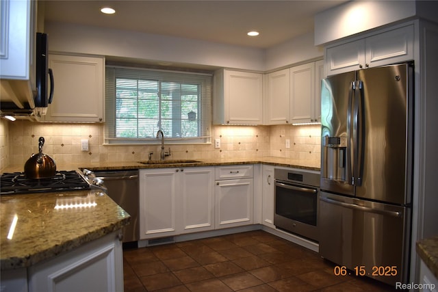 6560 Perham Dr, West Bloomfield, MI 48322 - kitchen with stainless steel appliances, backsplash, white cabinetry, light stone countertops, and recessed lighting