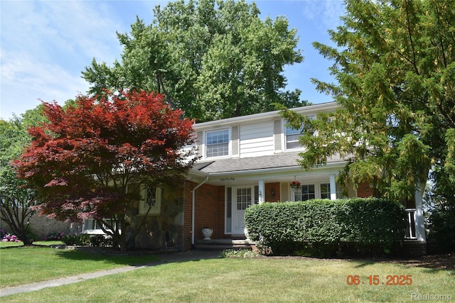 6560 Perham Dr, West Bloomfield, MI 48322 - traditional home featuring a front lawn, covered porch, brick siding, and stone siding
