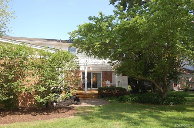 6560 Perham Dr, West Bloomfield, MI 48322 - obstructed view of property with brick siding, a front lawn, and a pergola
