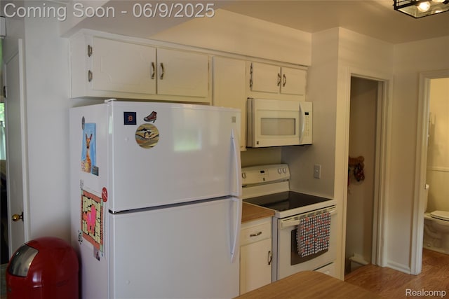 6009 Lancaster Dr, Flint, MI 48532 - kitchen with white appliances, white cabinetry, wood finished floors, and light countertops