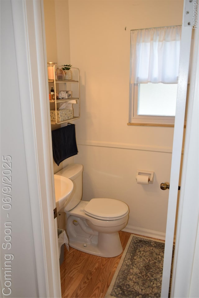 6009 Lancaster Dr, Flint, MI 48532 - bathroom with toilet and wood finished floors