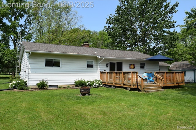 6009 Lancaster Dr, Flint, MI 48532 - rear view of property with an outdoor fire pit, a wooden deck, and a lawn