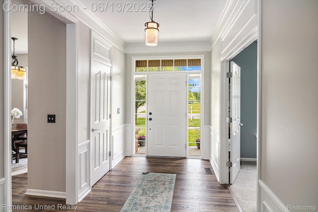 24168 Grand Traverse Ave, Flat Rock, MI 48134 - foyer entrance featuring dark wood-type flooring and ornamental molding