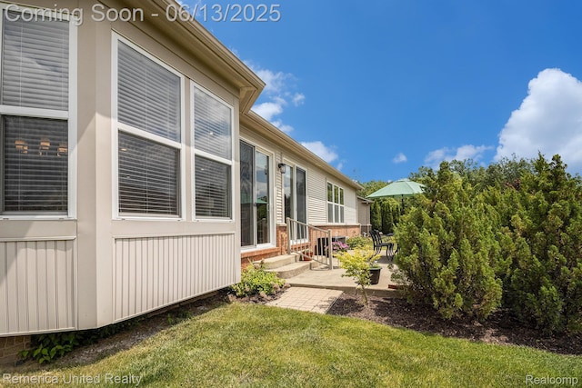 24168 Grand Traverse Ave, Flat Rock, MI 48134 - view of green lawn with entry steps and a patio