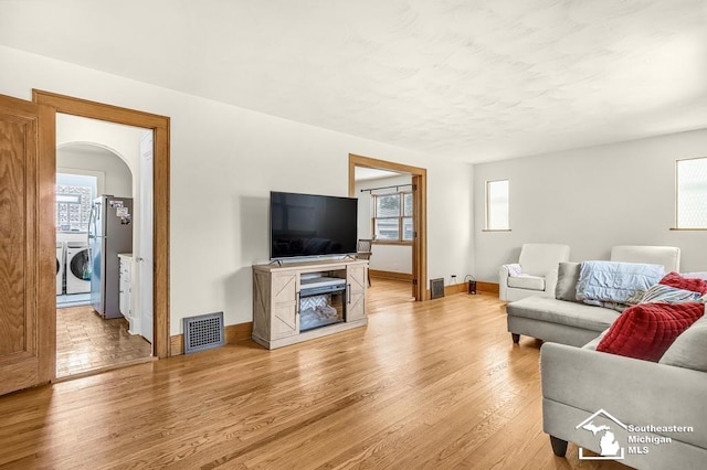 448 Borgess Ave, Monroe, MI 48162 - living room with washer / dryer, light wood-style flooring, and baseboards