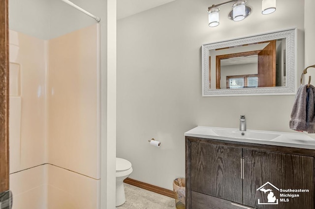 448 Borgess Ave, Monroe, MI 48162 - full bathroom featuring toilet, vanity, a shower, and baseboards