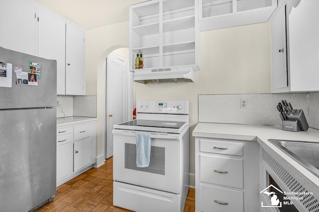 448 Borgess Ave, Monroe, MI 48162 - kitchen featuring freestanding refrigerator, under cabinet range hood, white electric range, open shelves, and decorative backsplash