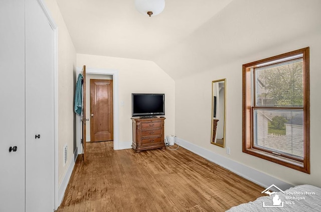 448 Borgess Ave, Monroe, MI 48162 - unfurnished bedroom featuring lofted ceiling, baseboards, and wood finished floors