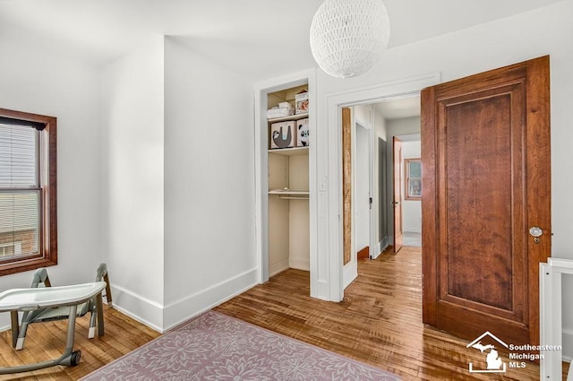448 Borgess Ave, Monroe, MI 48162 - bedroom with wood finished floors, a chandelier, and baseboards