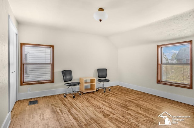 448 Borgess Ave, Monroe, MI 48162 - sitting room with lofted ceiling, wood finished floors, and baseboards
