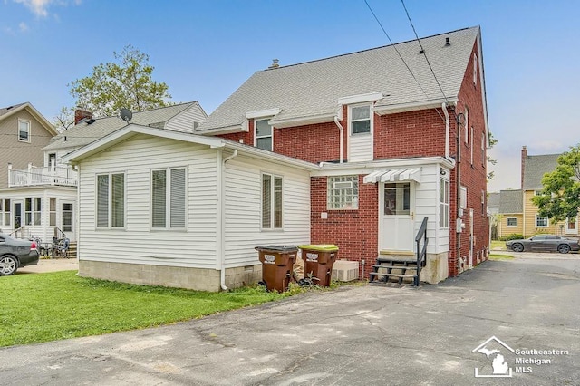448 Borgess Ave, Monroe, MI 48162 - rear view of property with entry steps, brick siding, and a yard