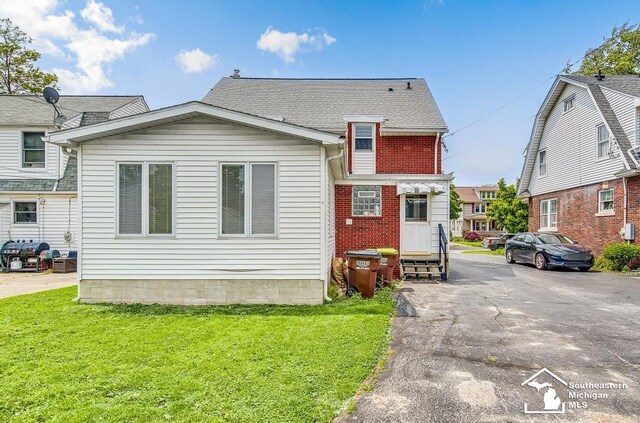 448 Borgess Ave, Monroe, MI 48162 - view of front of house featuring a front yard and brick siding