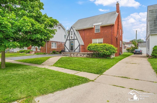 448 Borgess Ave, Monroe, MI 48162 - view of front of property with brick siding, a chimney, and a front yard