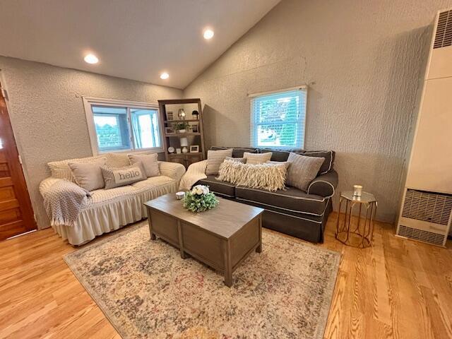 824 N Werners Landing Dr, Bronson, MI 49028 - living area featuring a heating unit, light wood finished floors, plenty of natural light, a textured wall, and recessed lighting