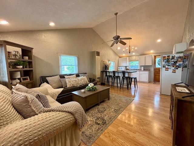 824 N Werners Landing Dr, Bronson, MI 49028 - living room with healthy amount of natural light, light wood-type flooring, ceiling fan, high vaulted ceiling, and a textured wall