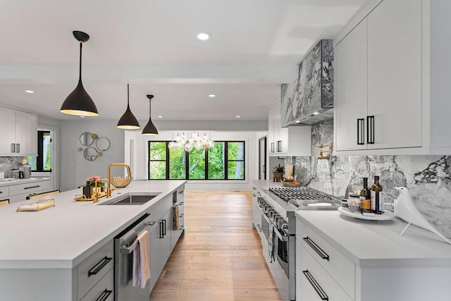 582 Campbell Rd, Saugatuck, MI 49453 - kitchen with a sink, appliances with stainless steel finishes, tasteful backsplash, light wood finished floors, and light countertops