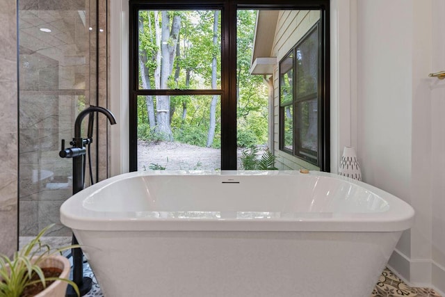 582 Campbell Rd, Saugatuck, MI 49453 - bathroom featuring a freestanding bath and a tile shower
