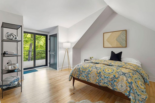 582 Campbell Rd, Saugatuck, MI 49453 - bedroom featuring access to outside, hardwood / wood-style floors, baseboards, and lofted ceiling