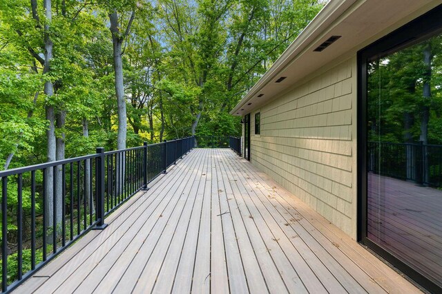 582 Campbell Rd, Saugatuck, MI 49453 - wooden terrace with view of wooded area