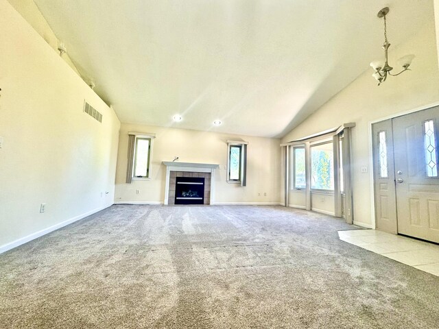 15338 Flanders St, Southgate, MI 48195 - unfurnished living room with carpet flooring, plenty of natural light, vaulted ceiling, a tile fireplace, and baseboards