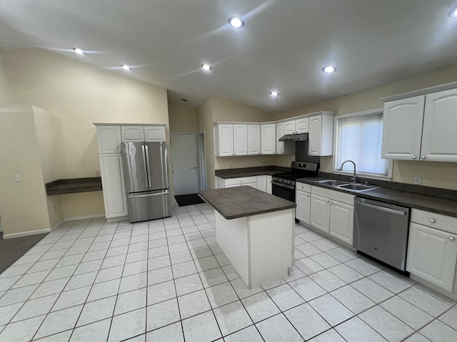 15338 Flanders St, Southgate, MI 48195 - kitchen with stainless steel appliances, a sink, dark countertops, vaulted ceiling, and under cabinet range hood