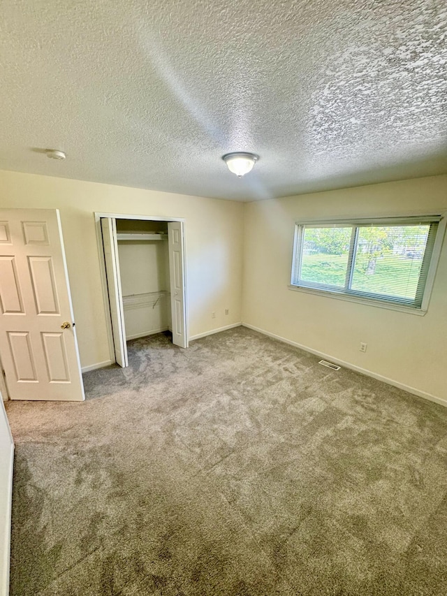 15338 Flanders St, Southgate, MI 48195 - unfurnished bedroom featuring carpet flooring, a closet, baseboards, and a textured ceiling