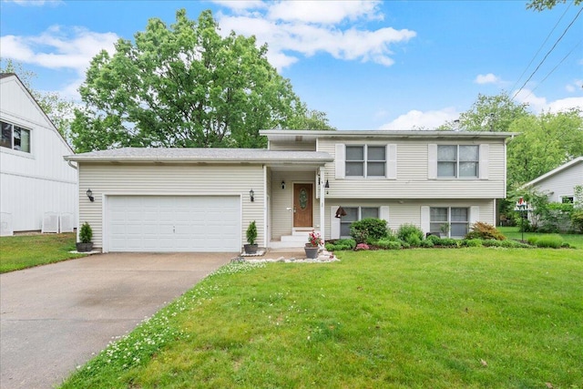 163 W 34th St, Holland, MI 49423 - tri-level home featuring an attached garage, a front yard, and driveway