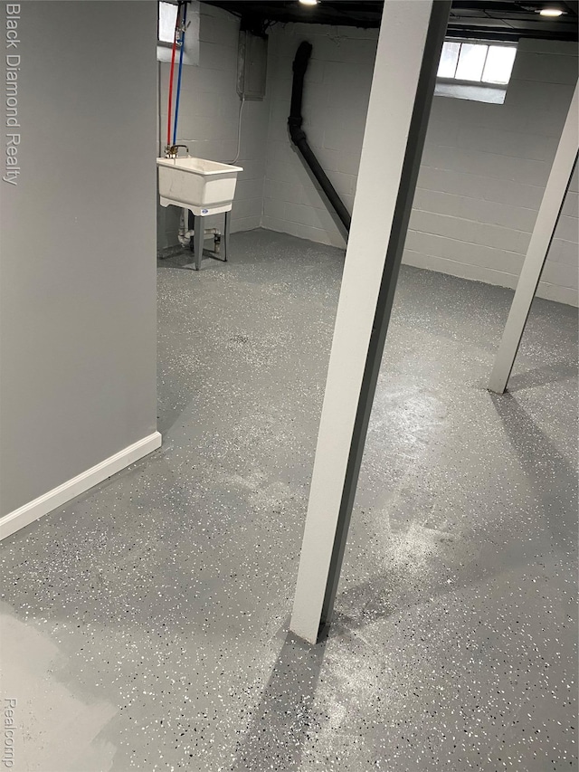 18499 Gruebner St, Detroit, MI 48234 - below grade area featuring a sink, electric panel, and concrete block wall