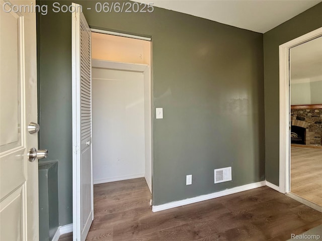 2105 Eberly Rd, Flint, MI 48532 - unfurnished bedroom featuring dark wood-type flooring, a closet, and baseboards