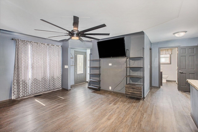 525 Riverview Ave, Monroe, MI 48162 - unfurnished living room with a ceiling fan, light wood-style flooring, and baseboards