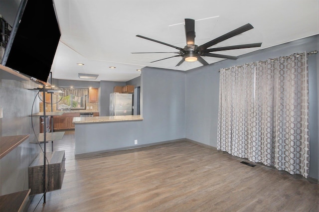525 Riverview Ave, Monroe, MI 48162 - unfurnished living room featuring light wood finished floors, ceiling fan, a sink, and baseboards